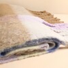 Close-up detail of folded soft brushed lilac and yellow check scarf