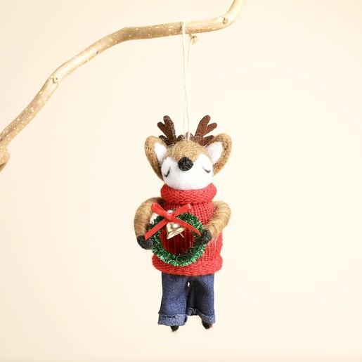 Felt reindeer hanging decoration suspended from a rustic wooden branch