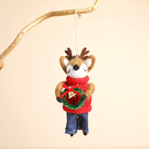 Felt reindeer hanging decoration suspended from a rustic wooden branch