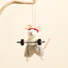 Felt weightlifting mouse Christmas decoration hanging from a wooden branch.