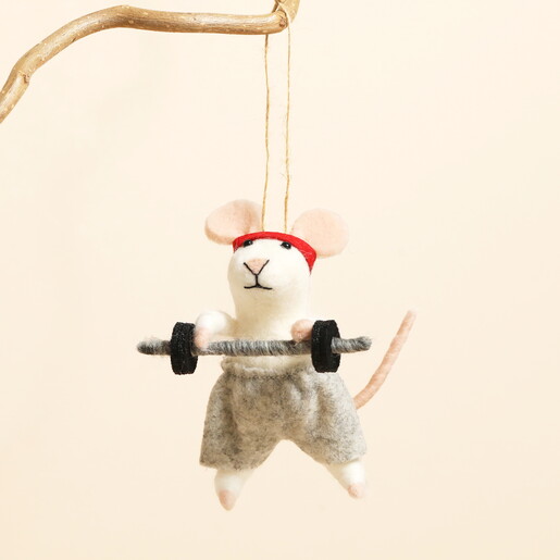 Felt weightlifting mouse Christmas decoration hanging from a wooden branch.