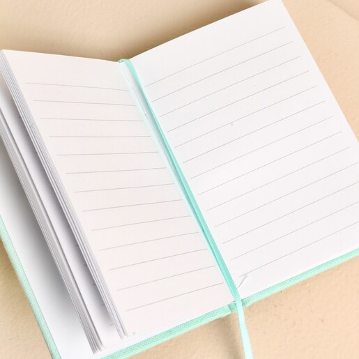 Open Ohh Deer A7 fabric notebook showing lined pages and ribbon bookmark