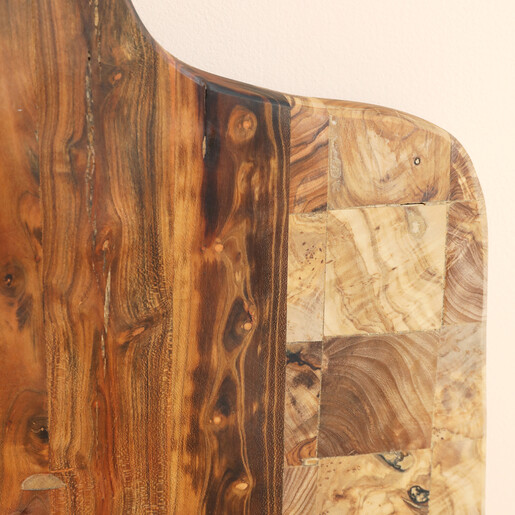 Close-up of the natural wood grain and checkered pattern on the olive wood board