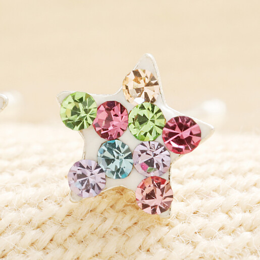 Close-up of a sterling silver star stud with pastel rainbow crystals.