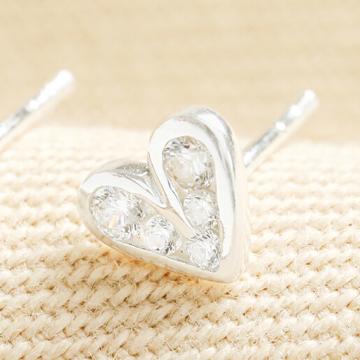 Close-up of a sterling silver heart stud earring with clear crystals.
