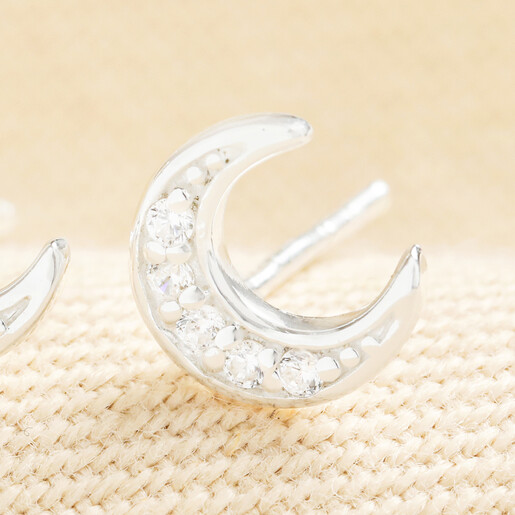 Close up of a sterling silver cubic zirconia crescent moon stud earring.