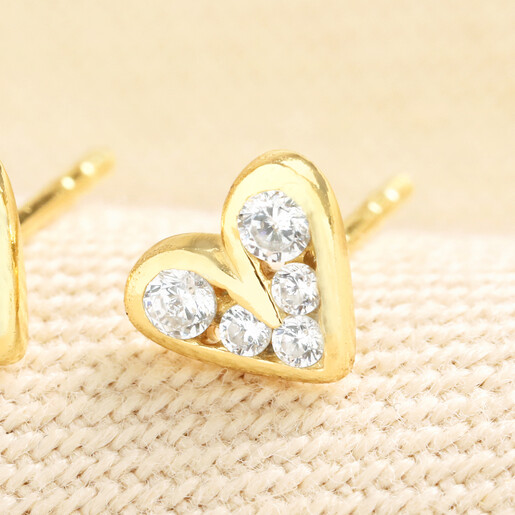 Close-up of gold sterling silver heart stud earring with cubic zirconia crystals