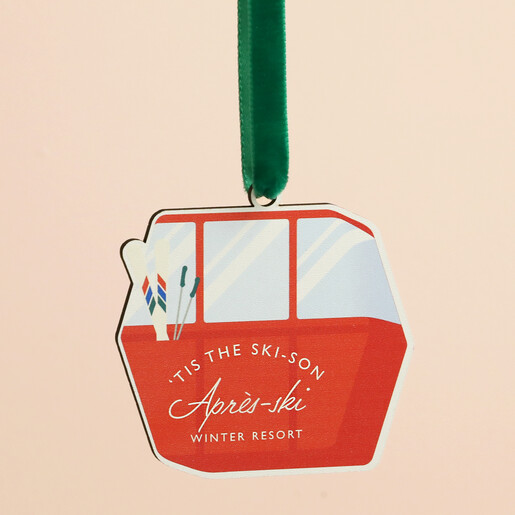 Close up view of the red wooden ski cable car ornament with green velvet ribbon