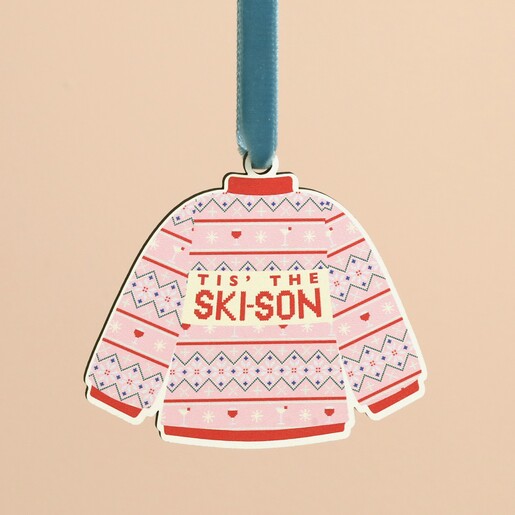 Close-up of wooden Tis The Ski-son jumper Christmas decoration with blue velvet ribbon