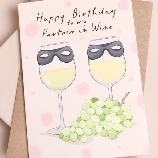 Close-up of illustrated wine glasses and grapes on Partner in Wine birthday card.