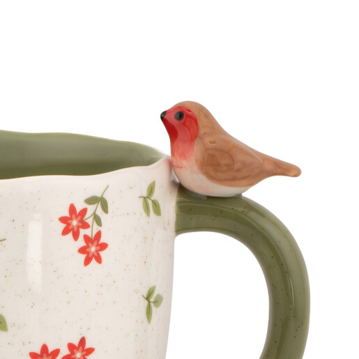 Close up of ceramic mug featuring a sculpted robin perched on the handle