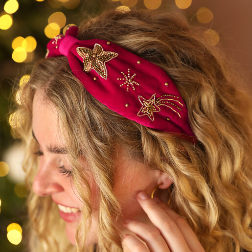 model shot of pink headband against sparkly background