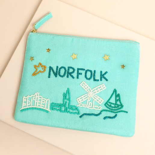 Light blue velvet pouch with beaded Norfolk lettering, coastal motifs and gold stars