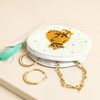 Open beaded cat purse revealing gold hoop earrings and chain necklace inside