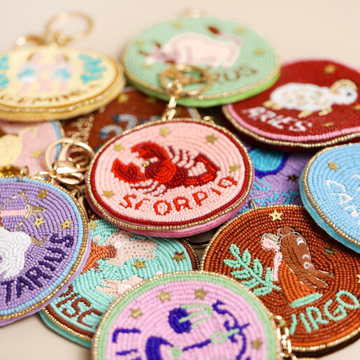 close up of zodiac keyring and bag charm