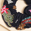 Close Up of Intricate Beaded Detail on Velvet Scrunchie