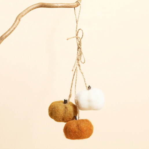 Felt mini pumpkin cluster decoration hanging from a branch