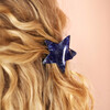 blue star-shaped hair clip on blonde hair 