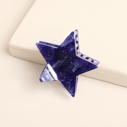 Top-down view of the small blue star hair clip with shimmer.