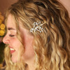 Woman wearing gold crystal multi star clip in wavy blonde hair