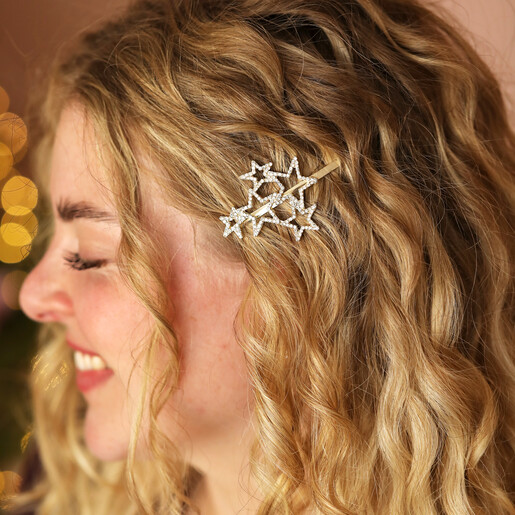 Woman wearing gold crystal multi star clip in wavy blonde hair