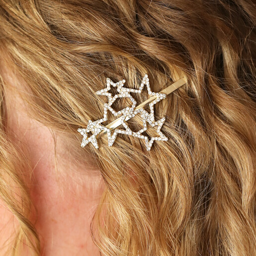 Close-up of sparkling gold multi star hair slide styled in curly hair