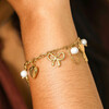 model shot of feminine charm bracelet in gold