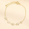 Gold stainless steel bracelet featuring crystal MUMMY letter charms on a delicate trace chain
