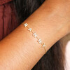 close up of crystal charm bracelet in gold