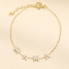 Gold stainless steel bracelet featuring crystal M A M A charms on a chain.