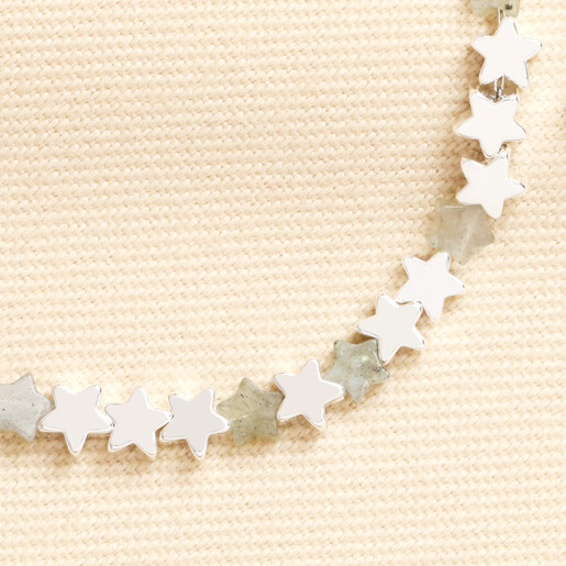 Close up of grey semi-precious stone and silver star beads on delicate bracelet
