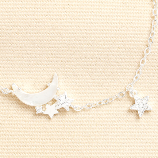 Close-up of iridescent mother of pearl crescent moon and crystal star charms