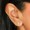 gold stud earrings on model