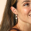clover-shaped drop earrings on model