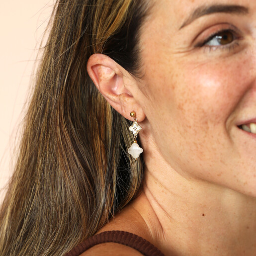 clover-shaped drop earrings on model