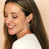 model shot of gold huggie hoop earrings