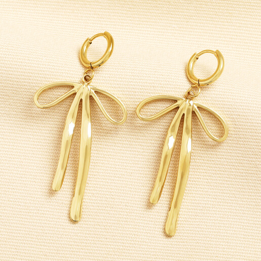 Gold stainless steel huggie hoop earrings with large hanging ribbon bow charms