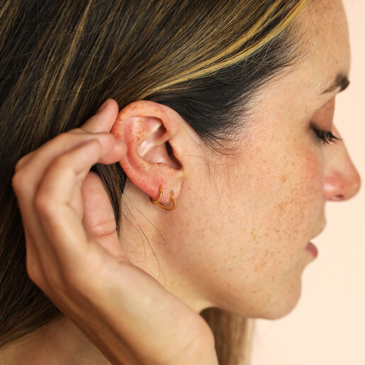 waterproof heart huggie hoop earrings on model