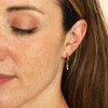 model shot of waterproof huggie earrings in gold