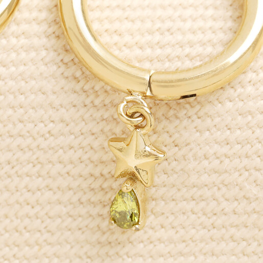 Close up of gold star charm with dangling teardrop green crystal