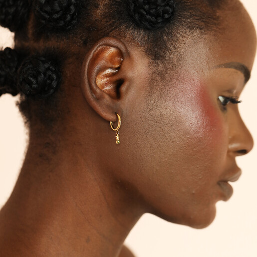model shot of gold star earrings