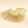 Close up of a gold stainless steel fan stud earring showing radiating rays
