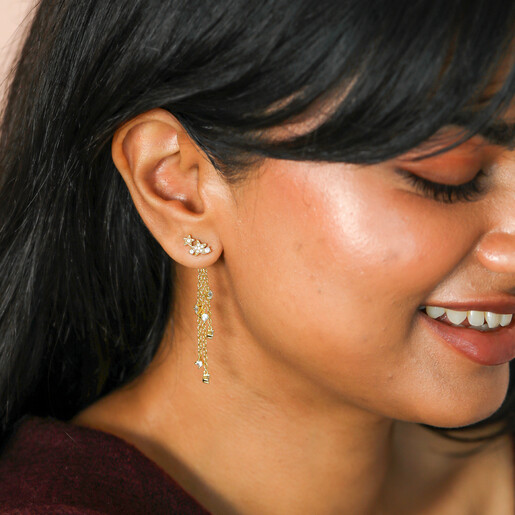 model shot of cascading celestial drop earrings in gold
