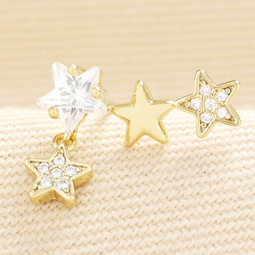 Close-up of gold crystal triple star climber earring showing cubic zirconia details