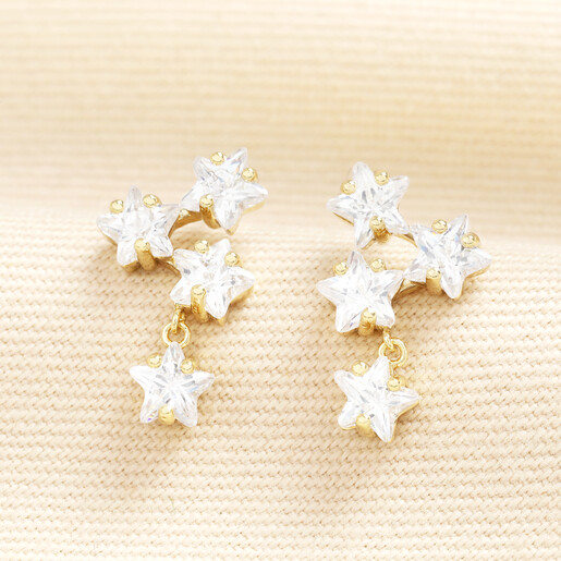 Pair of gold drop earrings featuring sparkling cubic zirconia triple star clusters