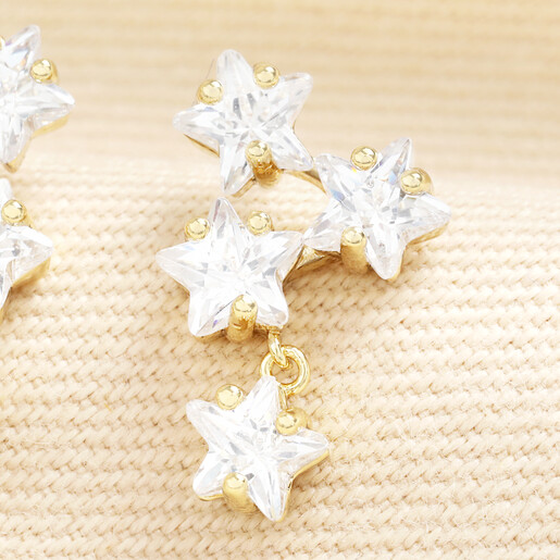 Close-up of gold cubic zirconia crystal star drop earring
