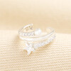 Silver wrap ear cuff adorned with clear crystals, a pearl, and a star crystal.