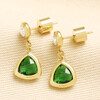 Pair of gold stainless steel drop earrings with faceted green glass triangle pendants