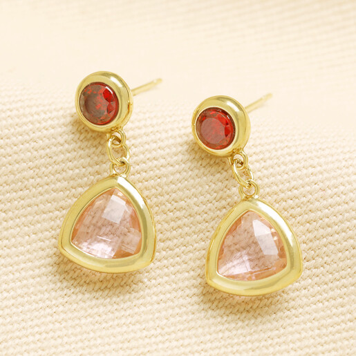 Pair of gold drop earrings with red crystal studs and pink triangle drops