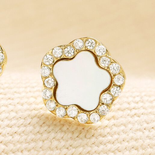Close-up of gold stainless steel flower stud earring with pearl and CZ details
